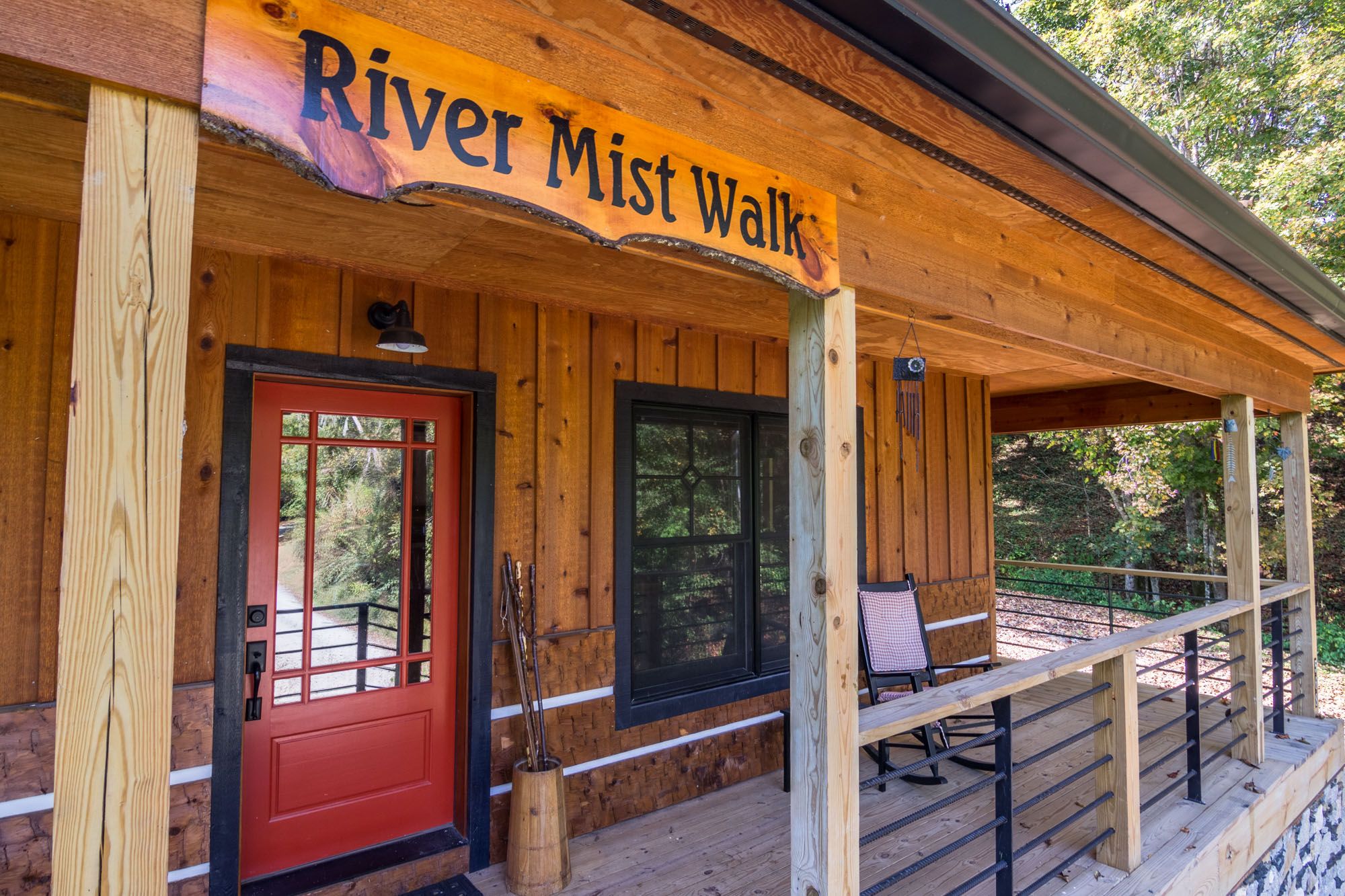 Exterior of cabin rental with red door and sign above door