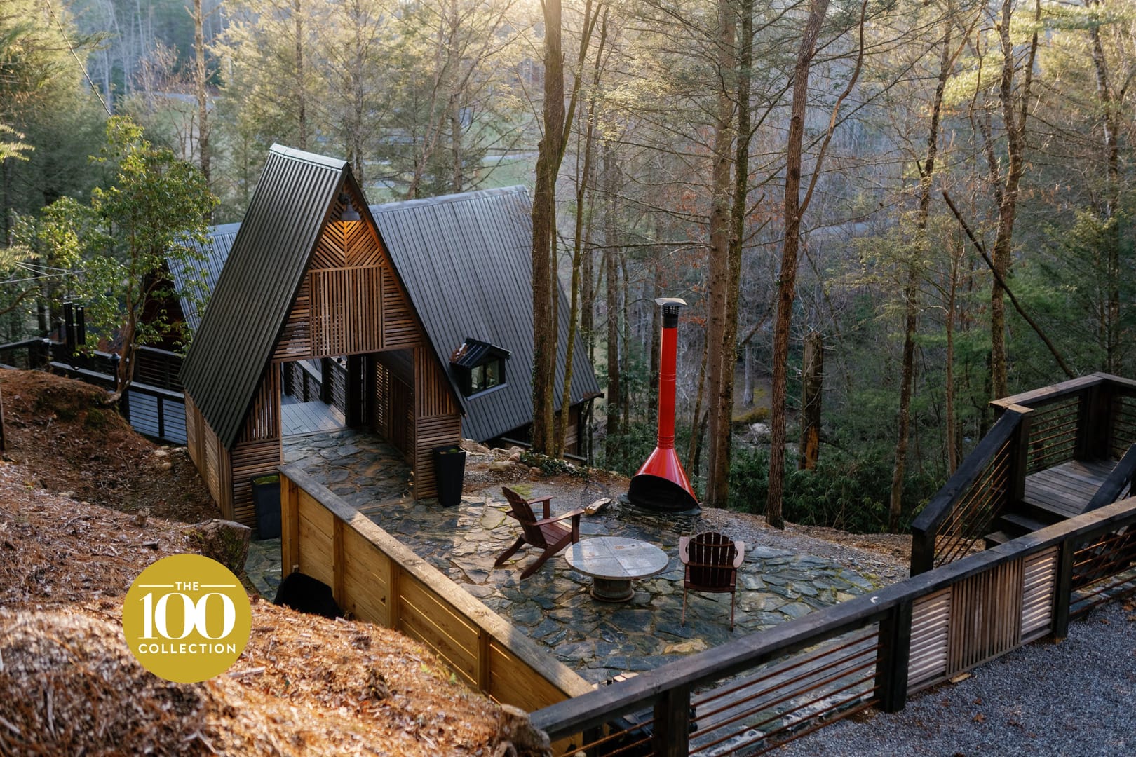 A fram cabin with outdoor firepit and forest trees in the background