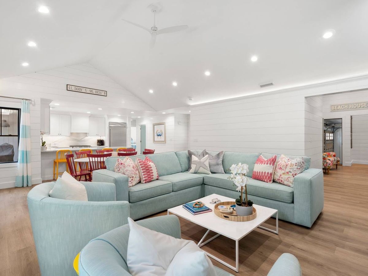 A luxurious beach house with private pool, shaded patios, and layered decks surrounded by palm trees. The ideal group getaway for soaking up Kiawah Island’s coastal charm.