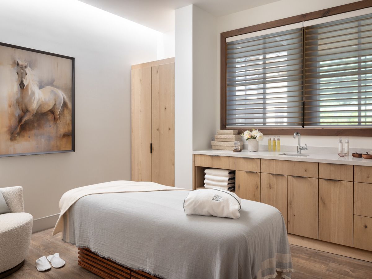 A serene treatment room at Body Sage Spa inside the Rusty Parrot Lodge features warm wood tones and a massage table ready for guests. The space feels quiet, cozy, and designed for deep relaxation. It’s a popular spa choice in downtown Jackson.