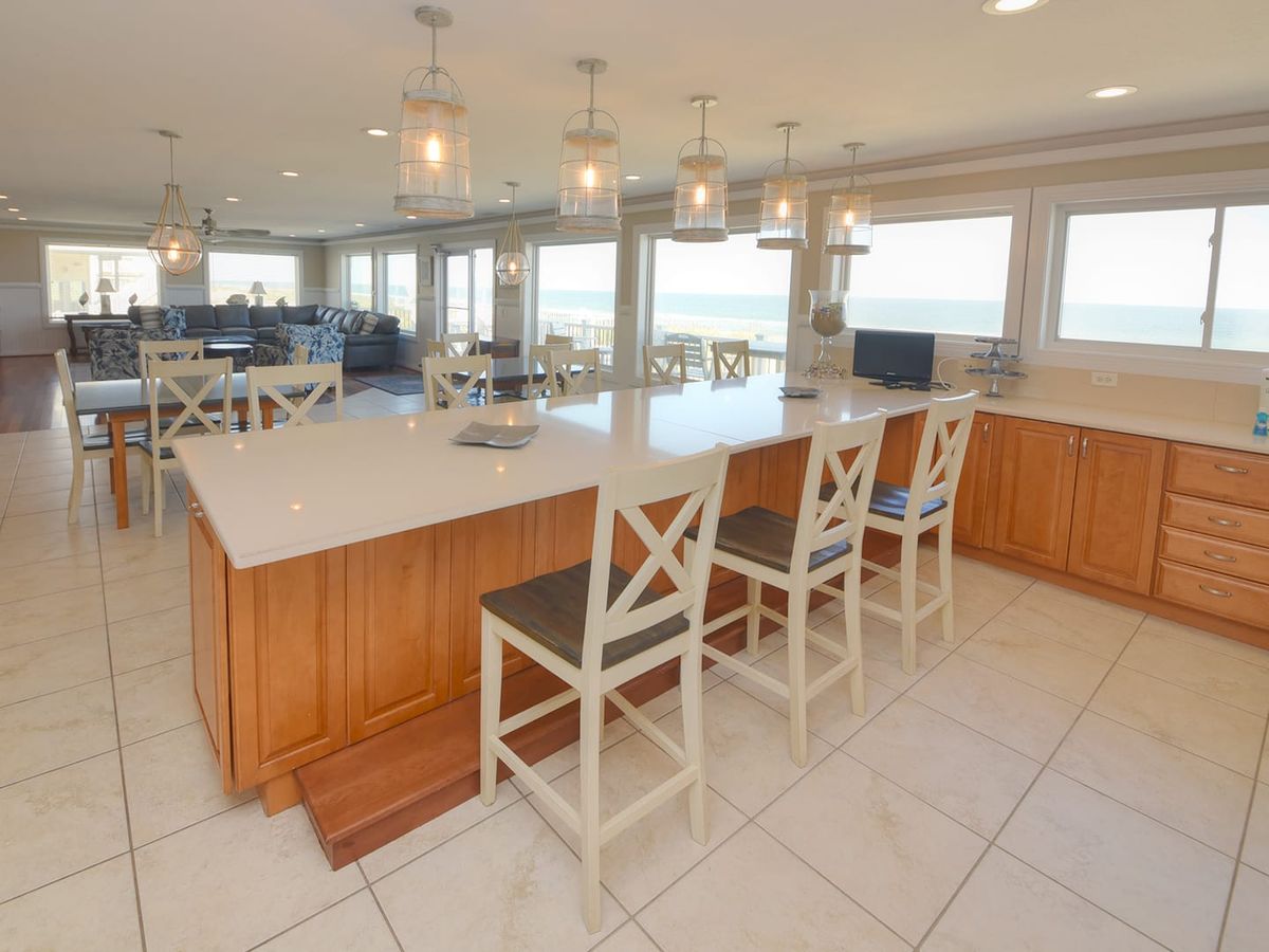 Elegant beach house featuring a large pool, expansive decks, and panoramic ocean views. Perfect for hosting family reunions or multi-family vacations by the sea.