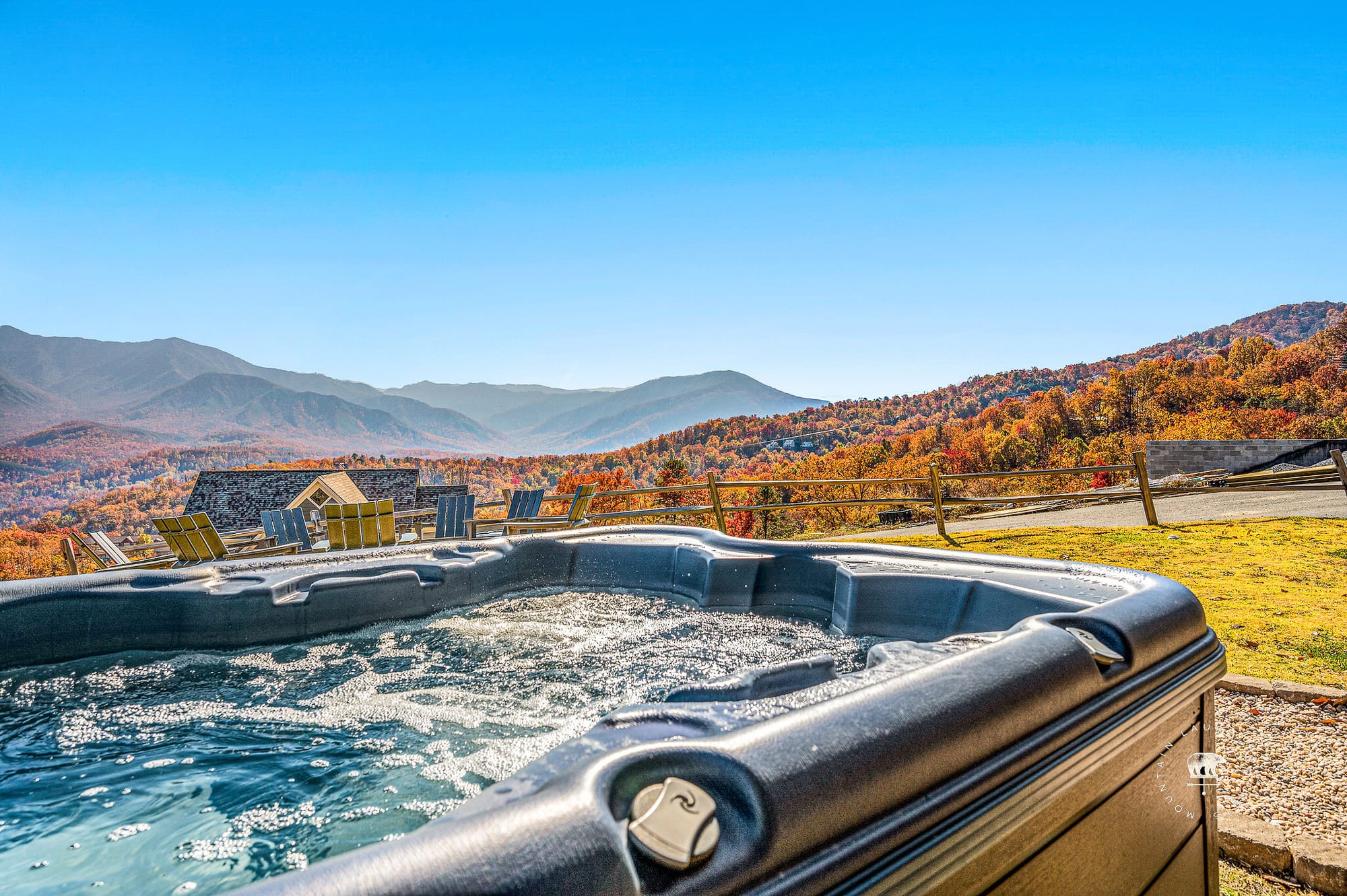 A bubbling hot tub overlooks sweeping mountain views and golden autumn colors. This spacious cabin offers comfort, adventure, and relaxation in Tennessee’s Smoky Mountains.