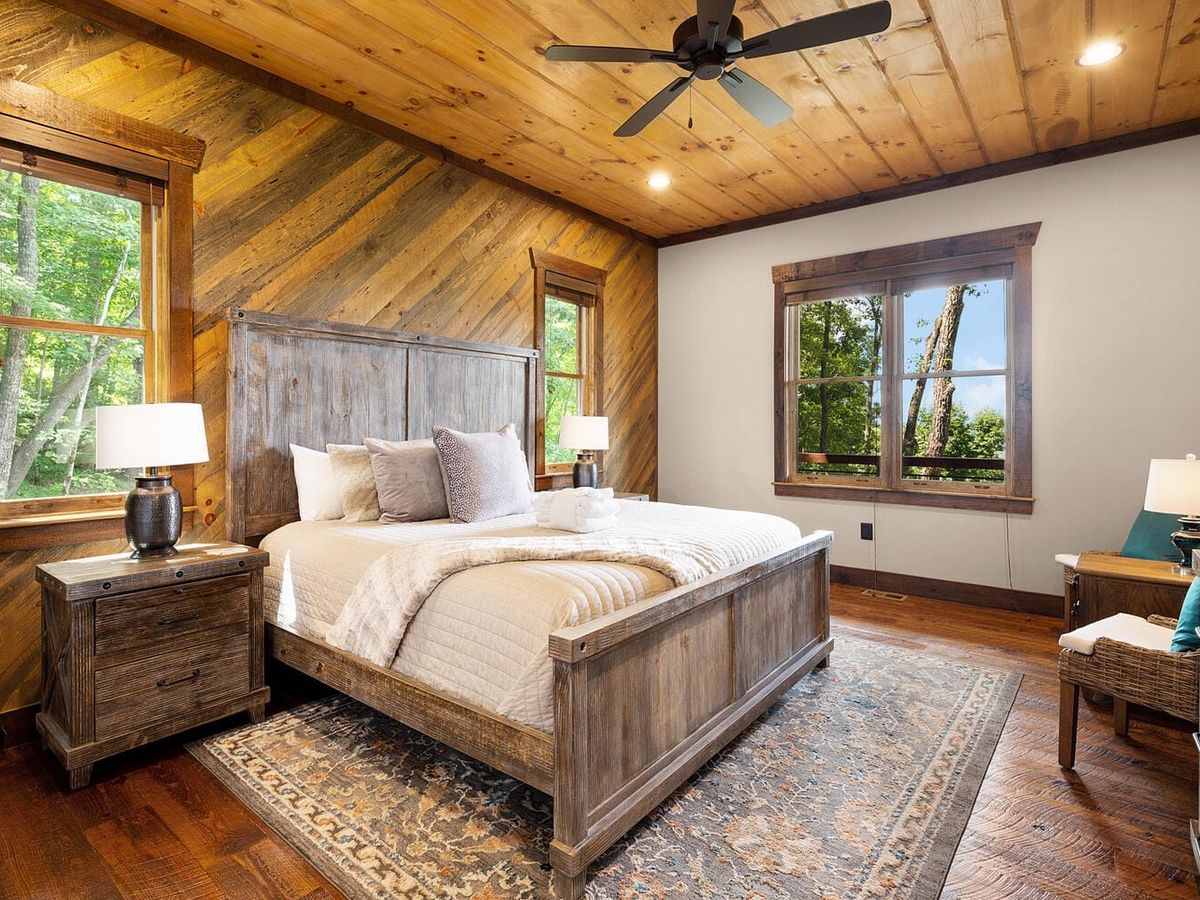 A shallow creek winds through a leafy forest, sunlight dancing across the water. The gentle flow and quiet woods suggest a nature-first way to unplug and feel balanced.