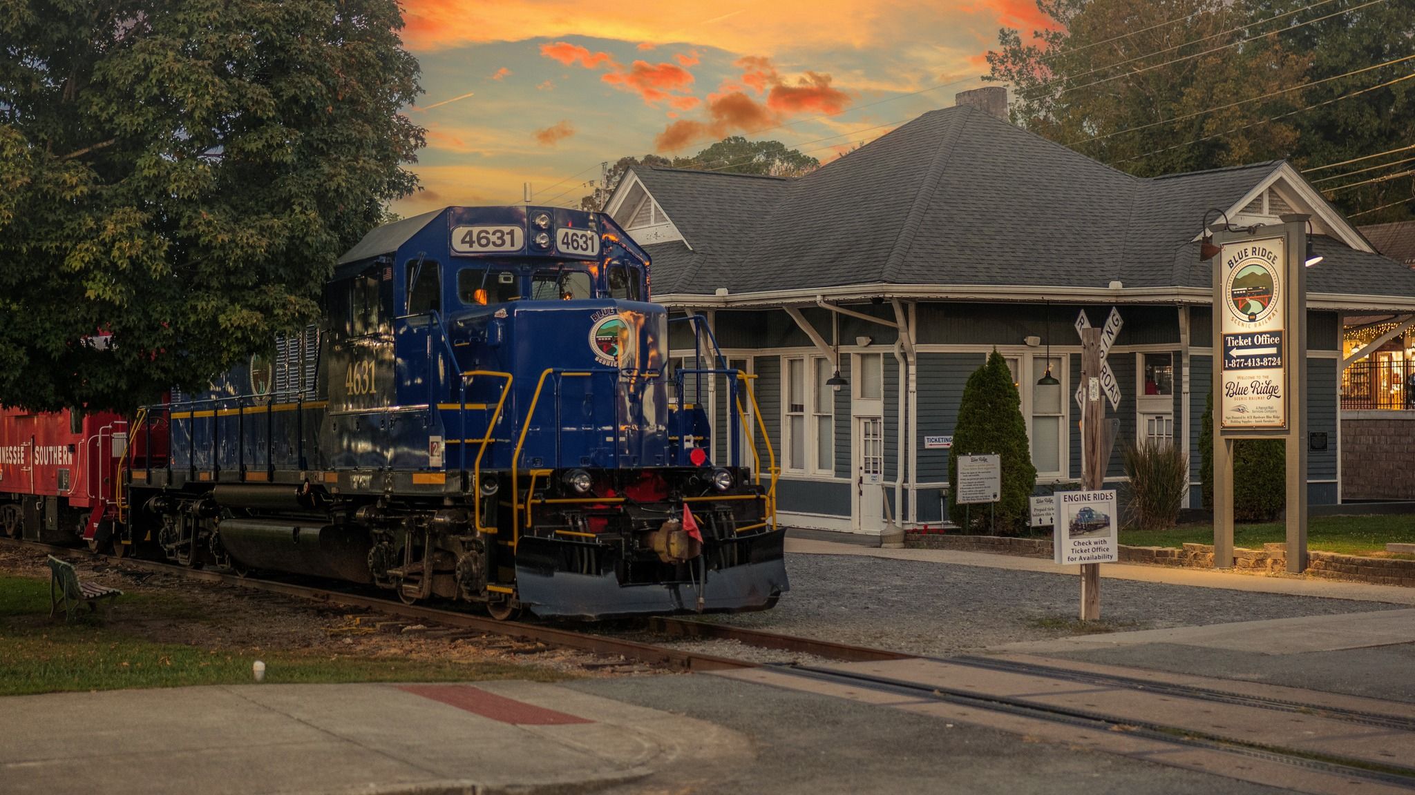 The Blue Ridge Scenic Railway train sits at the historic depot in downtown Blue Ridge during golden hour. This popular attraction offers scenic train rides through the North Georgia mountains, especially known for fall foliage and seasonal trips.