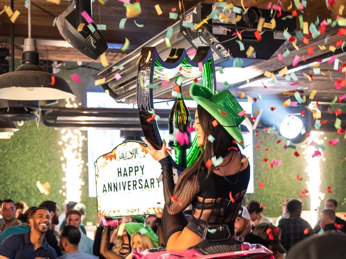 A high-energy celebration at Bottled Blonde in Scottsdale with confetti, music, and a packed crowd. This popular Old Town bar is known for late-night parties, DJs, and a lively nightlife scene.