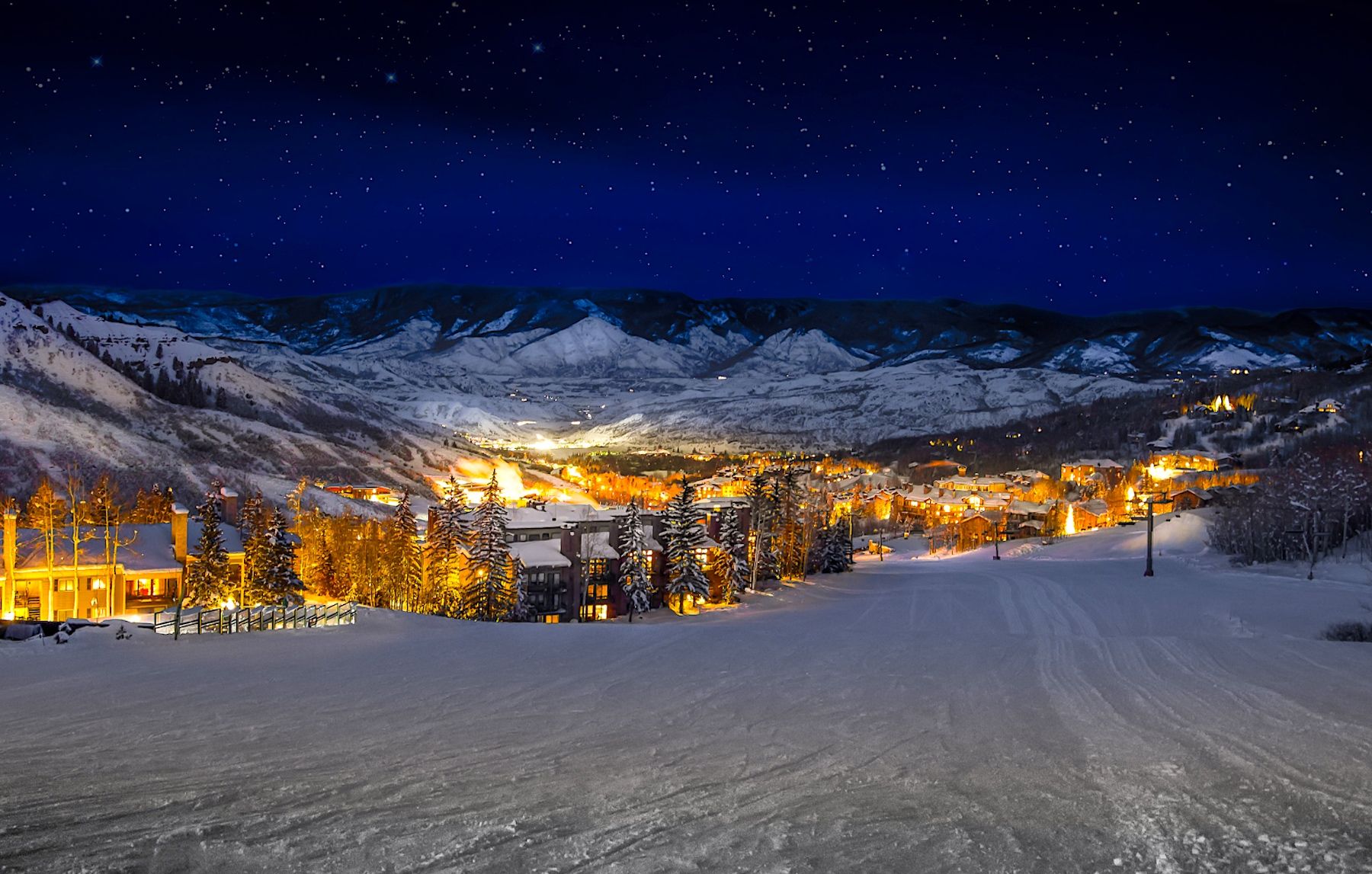 Aerial view of Snowmass Colorado from ski slopes during a winter night 