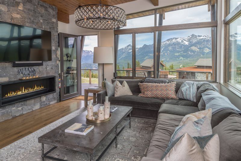 Living area with fireplace and mountain views in Big Sky