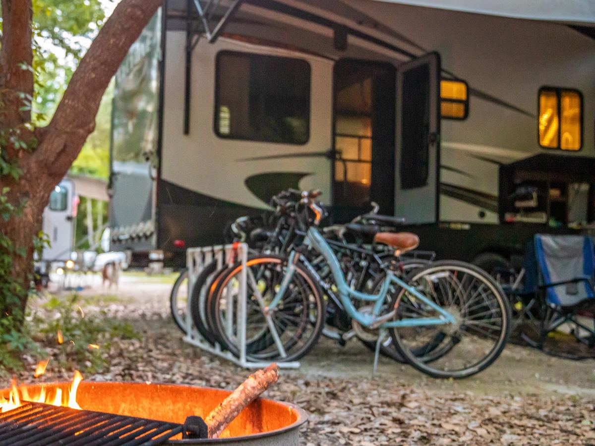 A camper setup at James Island County Park with bikes and a campfire area. This park is popular for camping, biking, and outdoor fun close to Charleston.