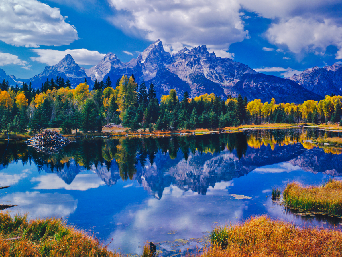 Mountain Range in Grand Tetons National Park Reflecting Off River in the Fall