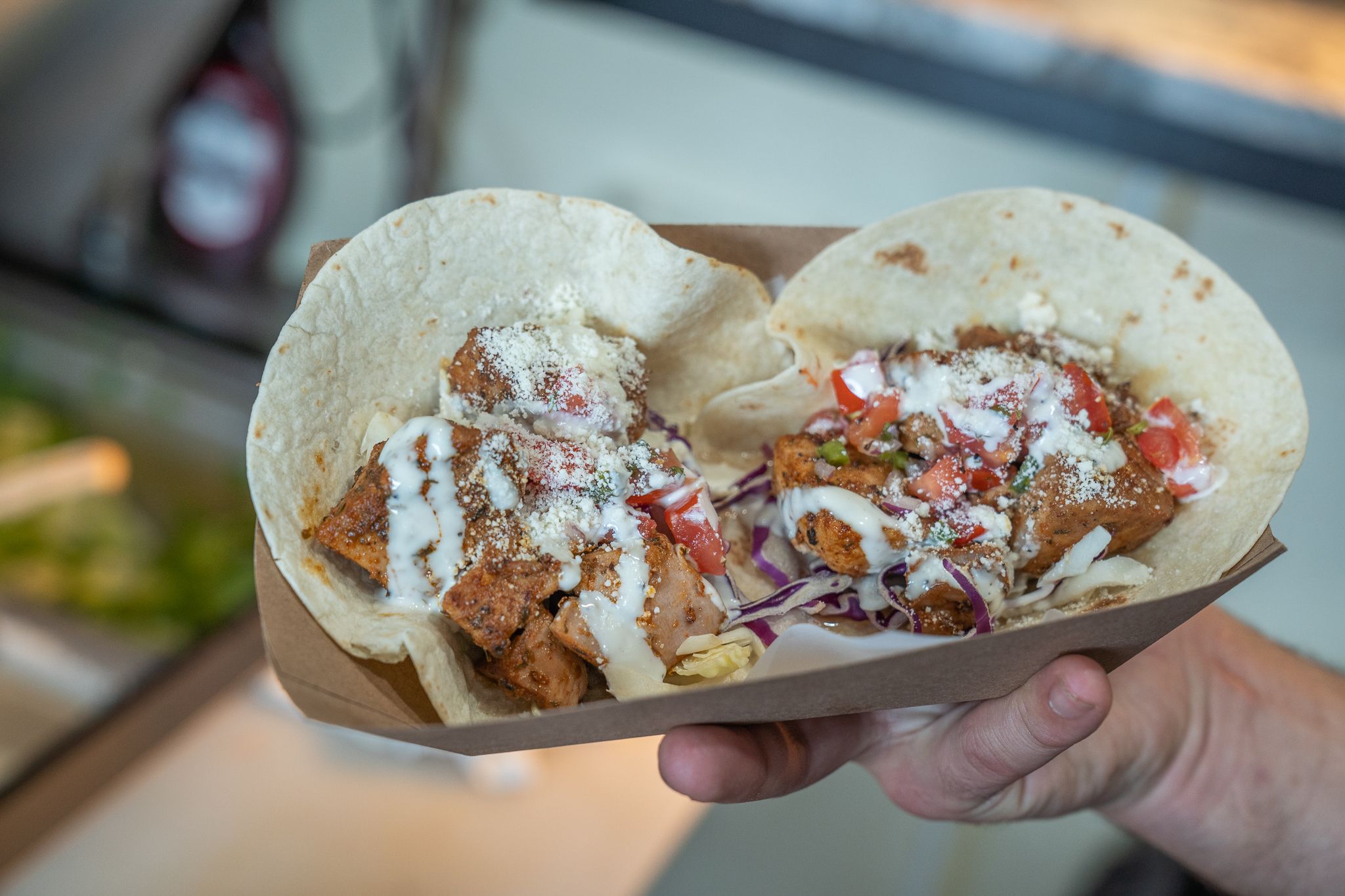 Fresh fish tacos filled with grilled seafood, cabbage, and creamy sauce are served at Kill Devil in the Outer Banks. The soft tortillas and colorful toppings highlight bold coastal flavors. It’s a popular stop for casual dining in the Outer Banks.