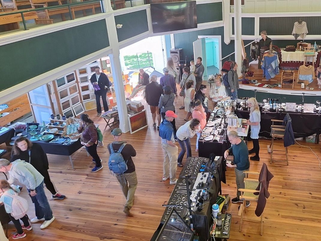 Visitors browse handcrafted jewelry, pottery, and artwork inside the historic Grange Hall during the Vineyard Artisans Festival. The event showcases the creativity and craftsmanship that make Martha’s Vineyard a hub for local artists.