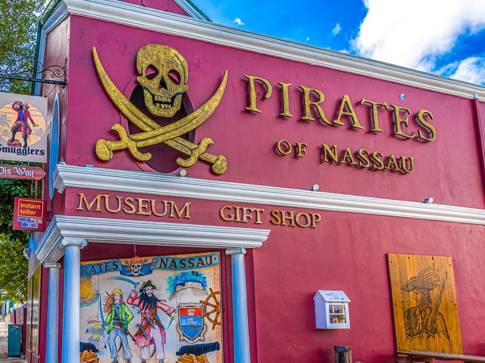 The bold red exterior of the Pirates of Nassau Museum with its golden skull-and-crossbones sign invites visitors to step into pirate history. A family-friendly attraction packed with interactive exhibits and seafaring tales.