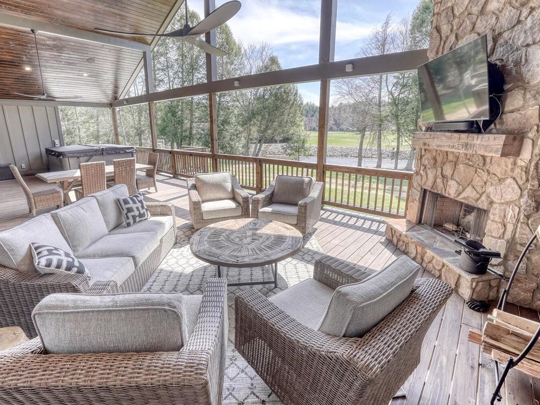 Spacious screened porch with soft seating and wide mountain views perfect for slow mornings and long chats. You’ll love the mix of comfort and nature, especially with a warm hot tub just steps away.