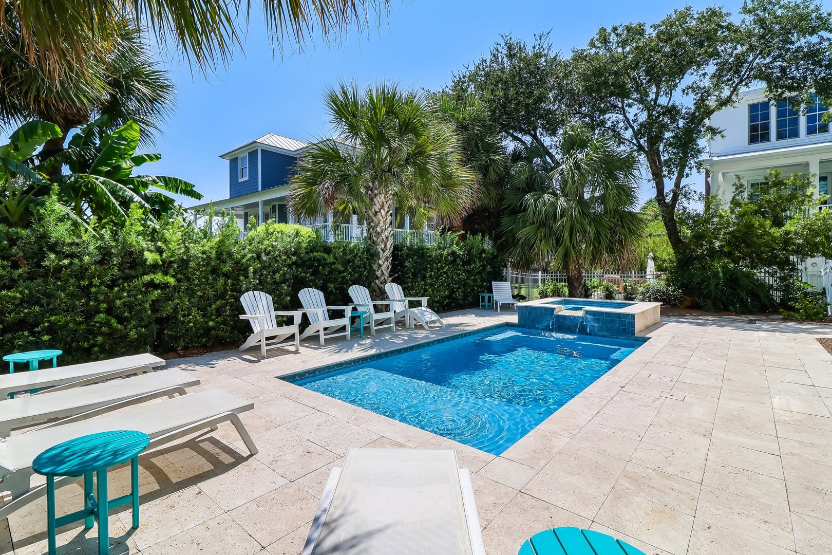 A private pool surrounded by palm trees and lounge chairs offers the perfect island retreat. The setup combines relaxation, comfort, and accessibility for vacationers of all needs.