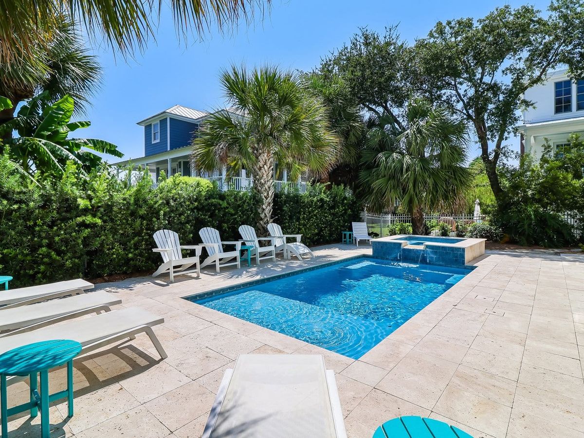 A private pool surrounded by palm trees and lounge chairs offers the perfect island retreat. The setup combines relaxation, comfort, and accessibility for vacationers of all needs.