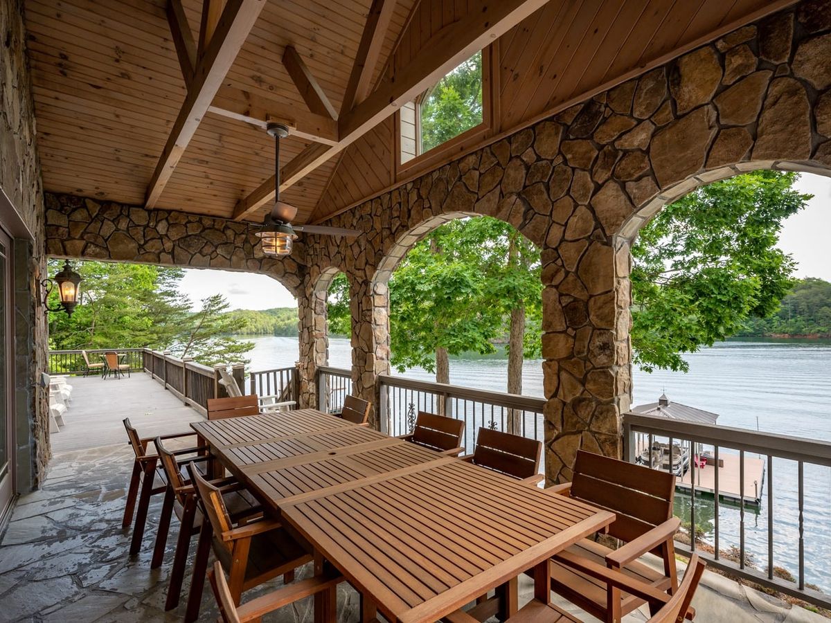 Wooden dining table with dinging chair outdoors with lake views