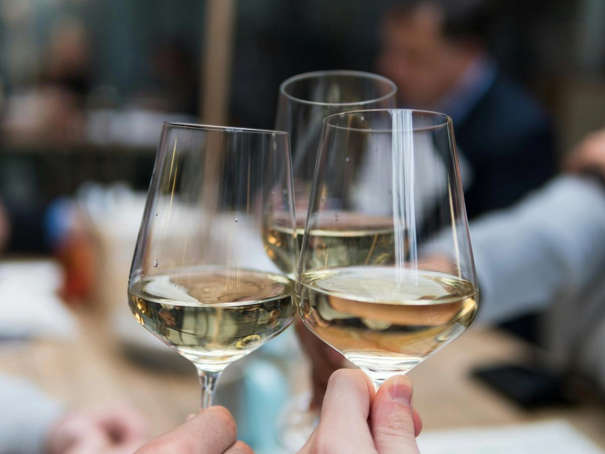 Three wine glasses clinking each other