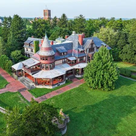 An aerial view of Sonnenberg Gardens and its historic mansion surrounded by manicured lawns and mature trees. This peaceful estate is one of the Finger Lakes’ most beautiful spots for garden walks and history lovers.