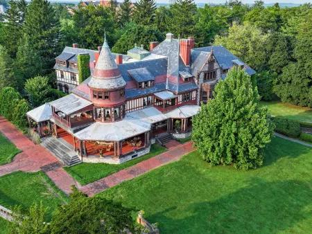 An aerial view of Sonnenberg Gardens and its historic mansion surrounded by manicured lawns and mature trees. This peaceful estate is one of the Finger Lakes’ most beautiful spots for garden walks and history lovers.