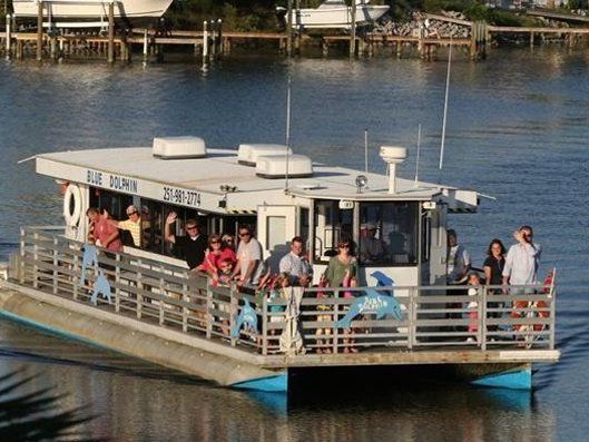 Guests enjoy a scenic ride aboard Blue Dolphin Cruises in Perdido Key, a family-friendly way to spot dolphins and take in the waterfront views.