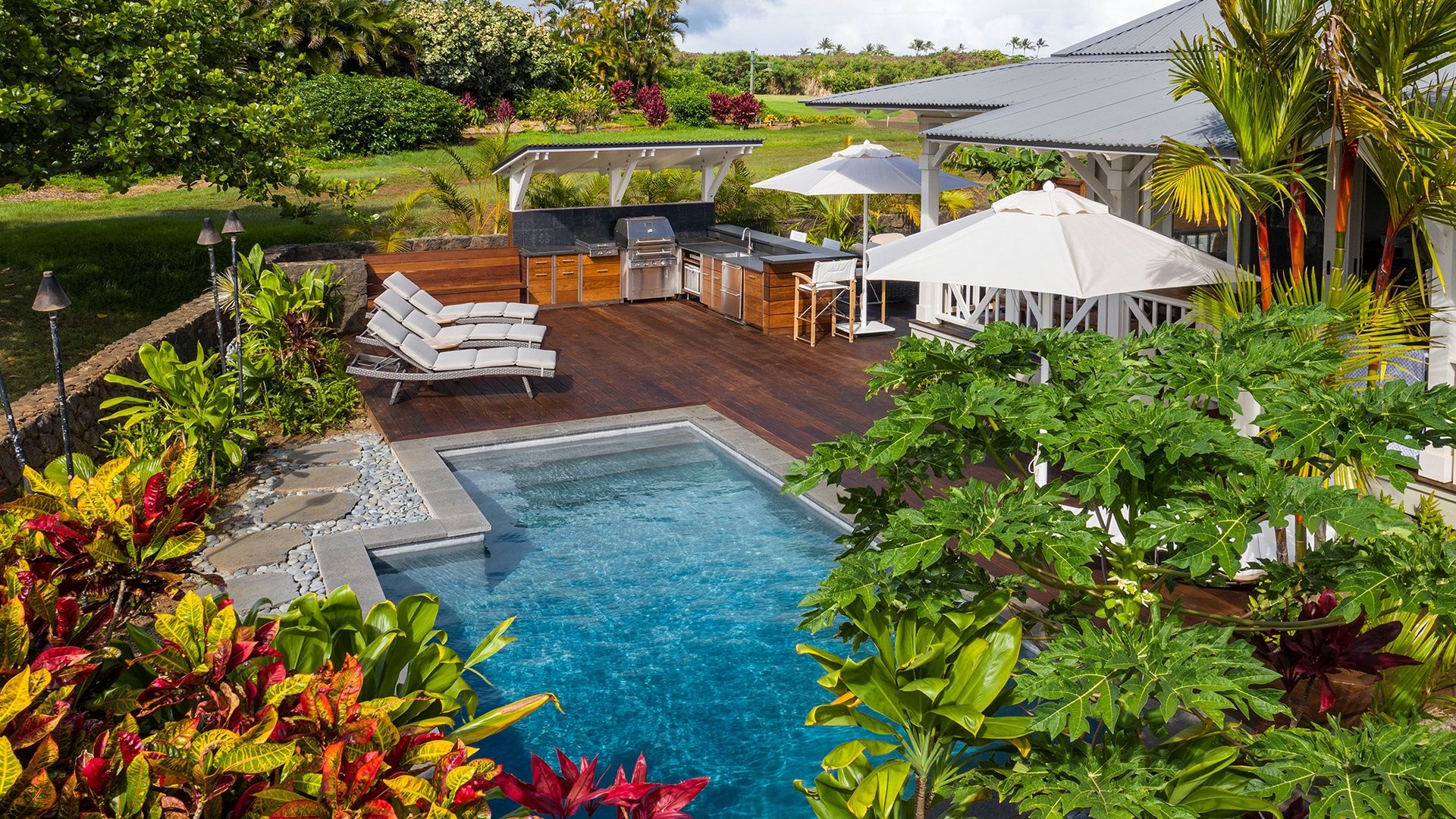 Backyard of Luxury Kauai Vacation Rental with Private Pool and Lush Vegetation