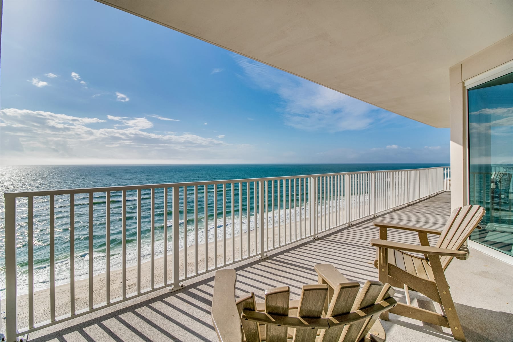 Enjoy endless Gulf views from this wide balcony featuring wooden chairs and open railings. It’s the perfect spot for sunrise coffee or a quiet evening by the ocean breeze.