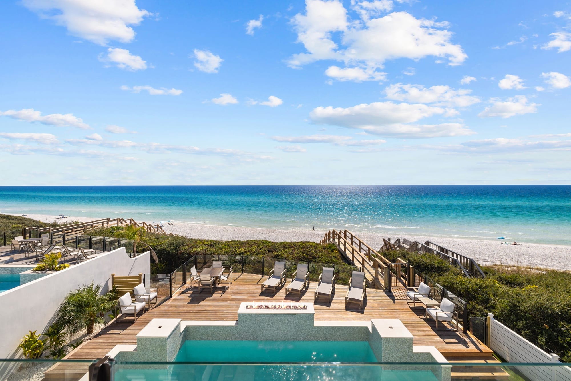 This luxury oceanfront deck on 30A features a private pool, lounge chairs, and direct beach access. Guests can relax by the pool while enjoying wide Gulf views and salty sea air. Villa Grandeur is ideal for group beach getaways with resort-style comfort.