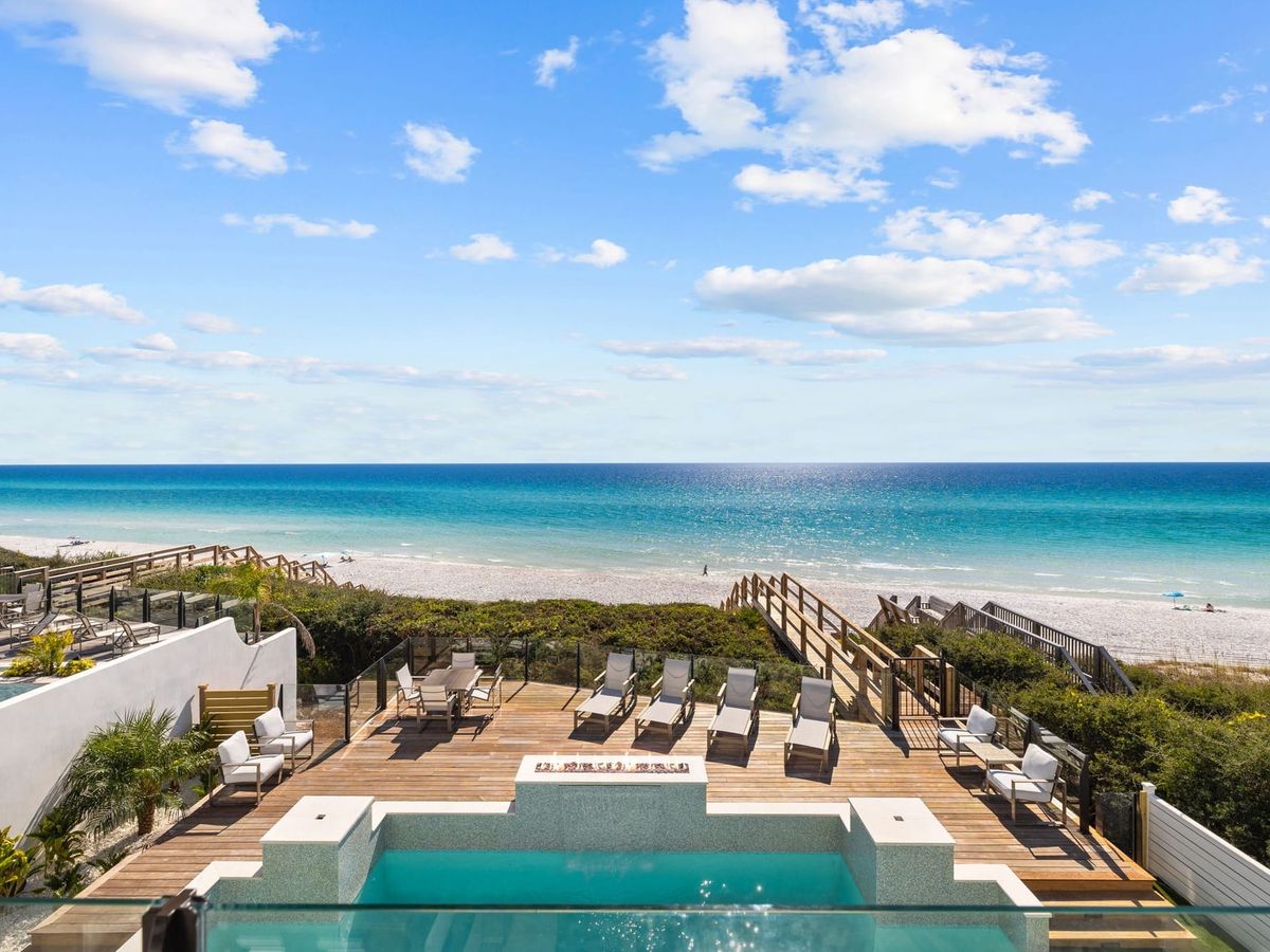 This luxury oceanfront deck on 30A features a private pool, lounge chairs, and direct beach access. Guests can relax by the pool while enjoying wide Gulf views and salty sea air. Villa Grandeur is ideal for group beach getaways with resort-style comfort.