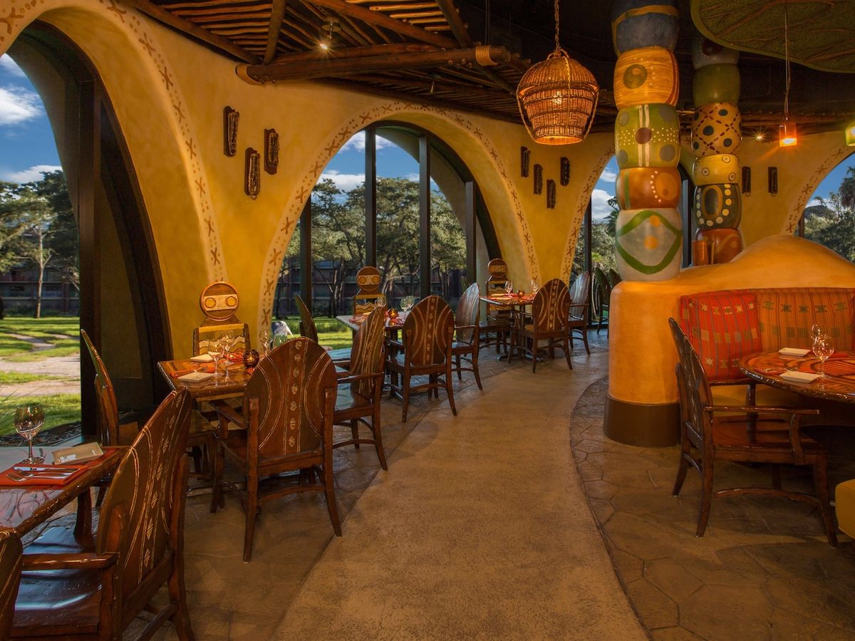Bright dining room at Sanaa with African-inspired design and sweeping views of Disney’s Animal Kingdom Lodge savanna. A one-of-a-kind dining atmosphere.
