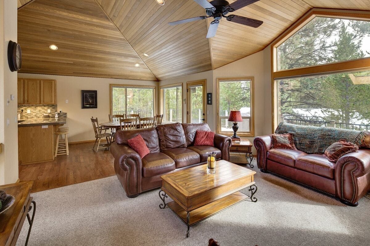 This charming cabin blends modern comfort with rustic charm, featuring a spacious deck with a hot tub and lounge area. Inside, the wood-beamed ceilings and cozy fireplace make it the perfect place to relax after a day of outdoor adventures. Surrounded by nature, it’s a quiet escape designed for comfort and connection.