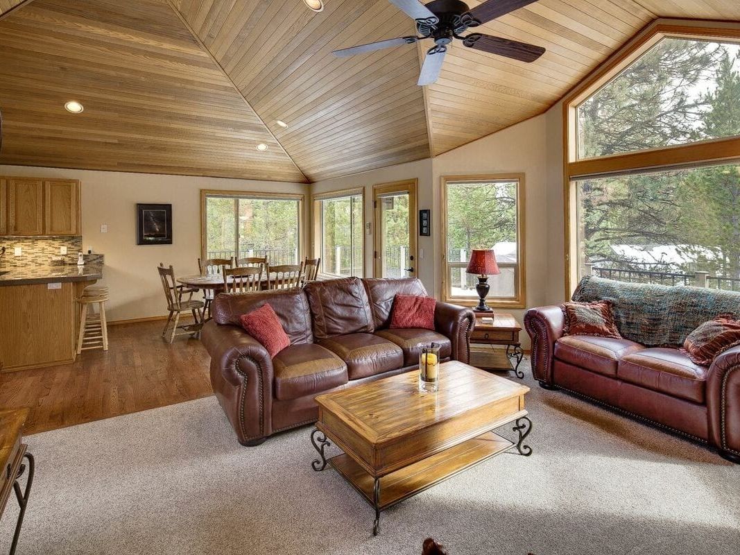 This charming cabin blends modern comfort with rustic charm, featuring a spacious deck with a hot tub and lounge area. Inside, the wood-beamed ceilings and cozy fireplace make it the perfect place to relax after a day of outdoor adventures. Surrounded by nature, it’s a quiet escape designed for comfort and connection.