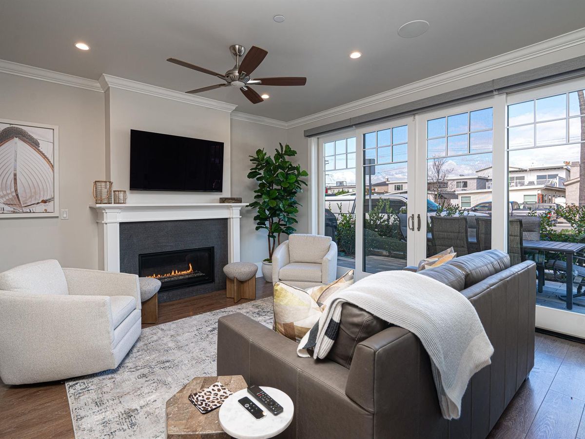 A rustic-chic beach house on the Outer Banks with cedar siding and a wraparound porch facing the ocean. The wide driveway and private beach access make this the perfect family retreat.