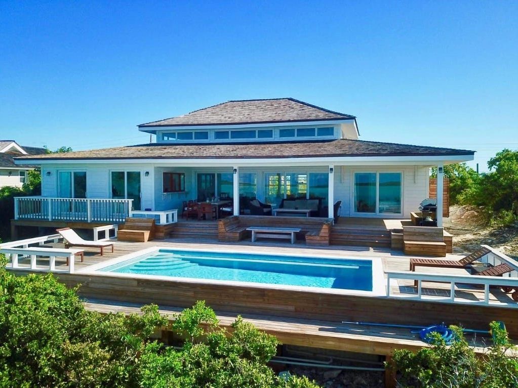 Modern beach house with ocean views, a private pool, and a large patio for sunbathing or family dinners. Great for a laid-back island vacation with friends.