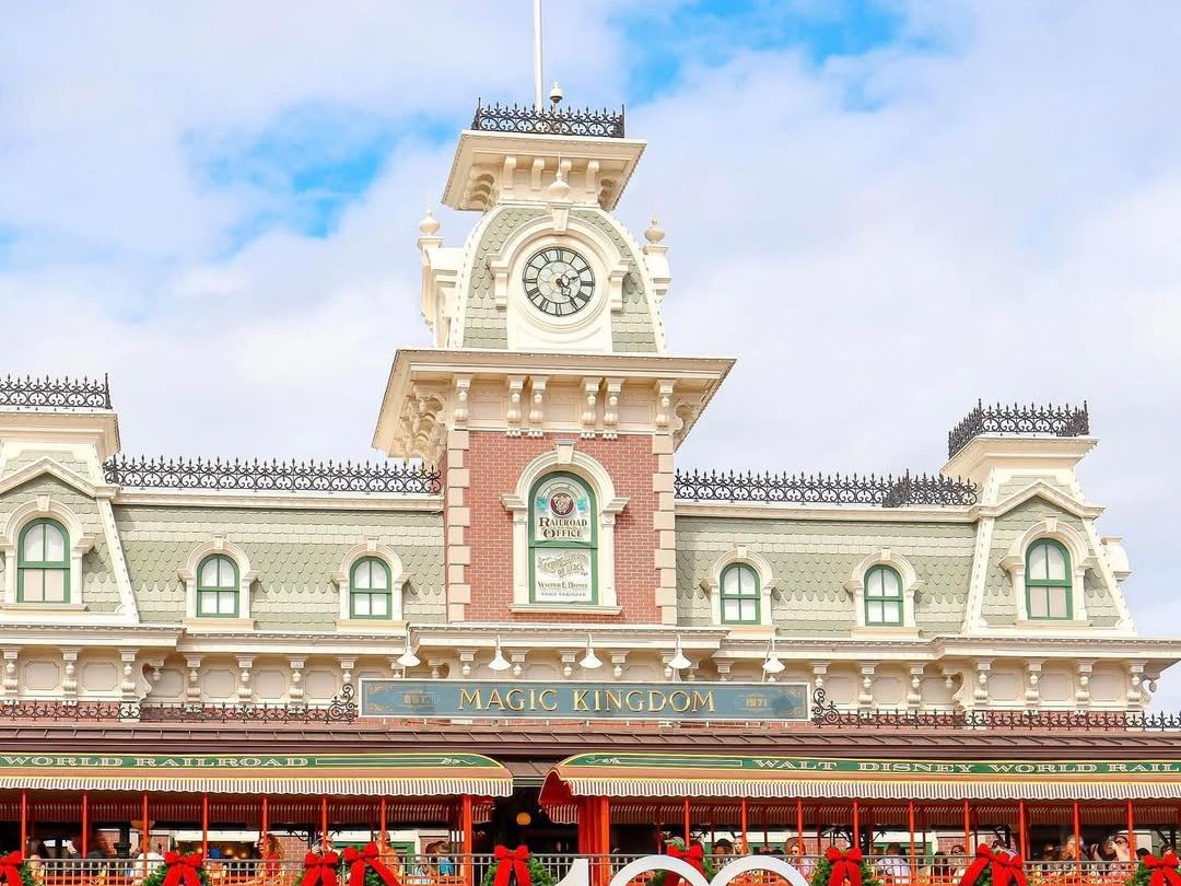 Magic Kingdom’s iconic train station decorated for the holidays at Walt Disney World. A must-see entrance to Disney’s magical theme park.
