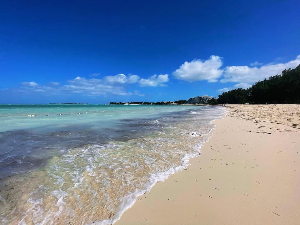 Waves gently roll onto Cable Beach, one of Nassau’s most famous stretches of sand, with resorts lining the horizon. A perfect spot to unwind, swim, and enjoy Bahamian sunshine.