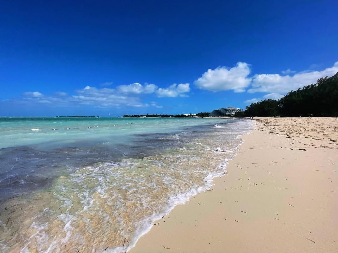 Waves gently roll onto Cable Beach, one of Nassau’s most famous stretches of sand, with resorts lining the horizon. A perfect spot to unwind, swim, and enjoy Bahamian sunshine.