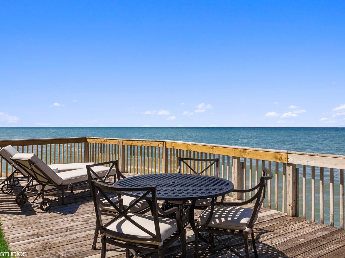 Peaceful waterfront deck with panoramic Lake Michigan views, perfect for lounging, stargazing, or watching your dog chase waves in the distance. A dream for beach lovers, pups included.