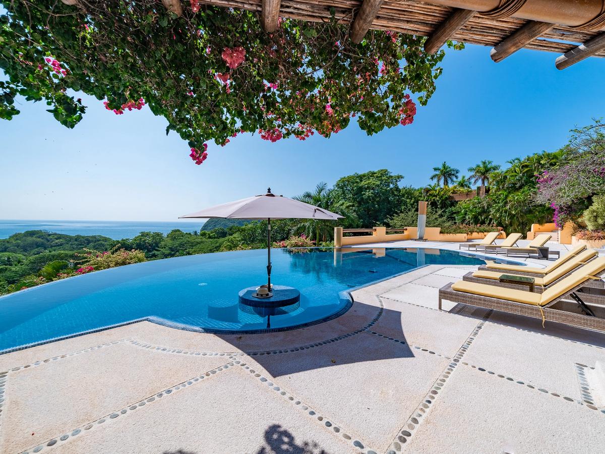 Huatulco Vacation Rental pool, lounge chairs and view of ocean