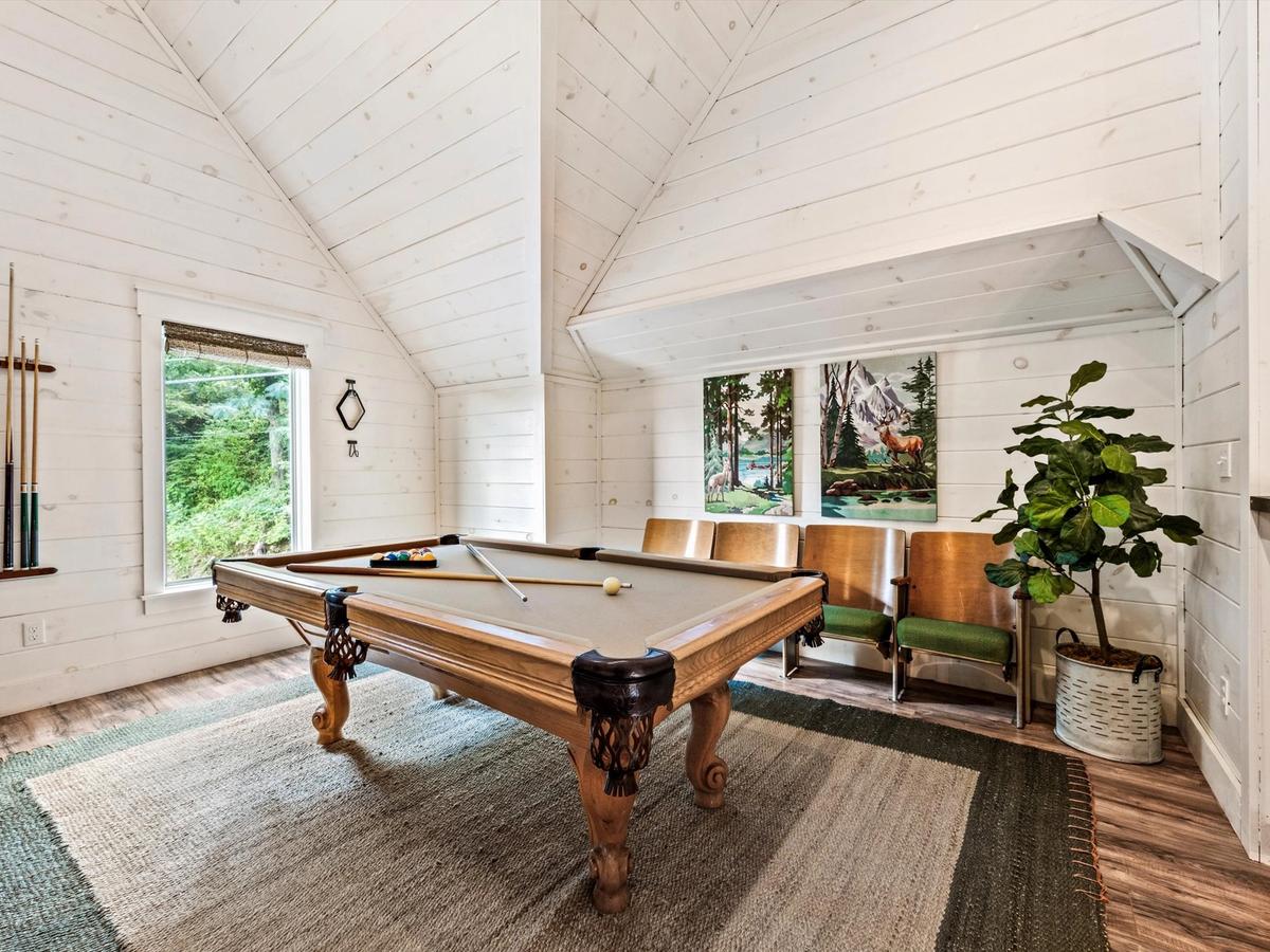 Pool table in game room with cool retro chairs