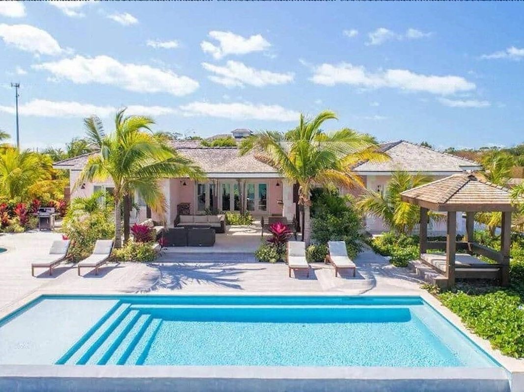 Spacious luxury home with a tropical garden, vibrant flowers, and a beautiful pool area. Ideal for large families who want a peaceful stay close to the beach.