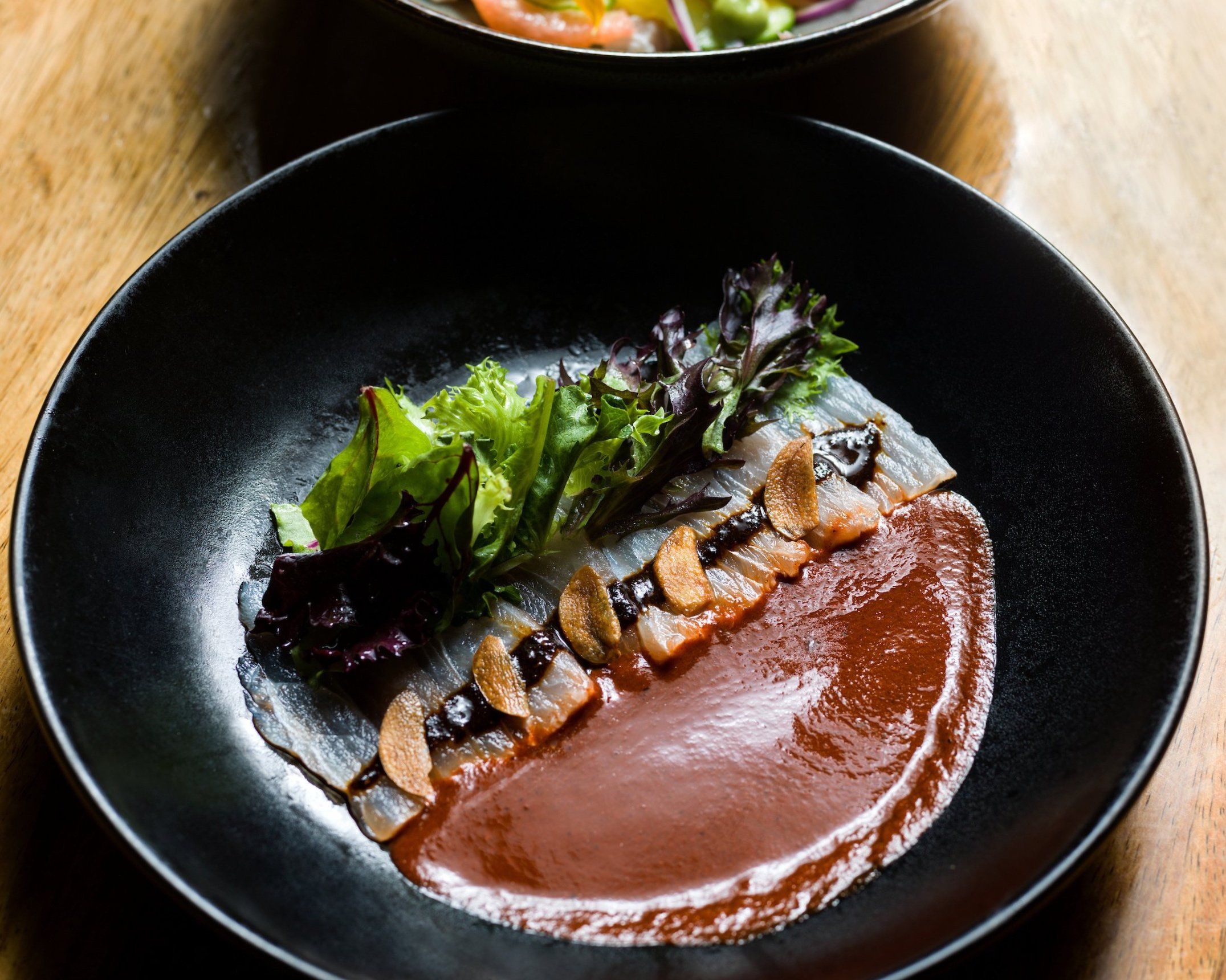 Overlooking the ocean at sunset, Outpost combines fine dining with unforgettable views of Cabo’s coastline. Guests savor expertly crafted dishes and cocktails as the golden light fades into evening.