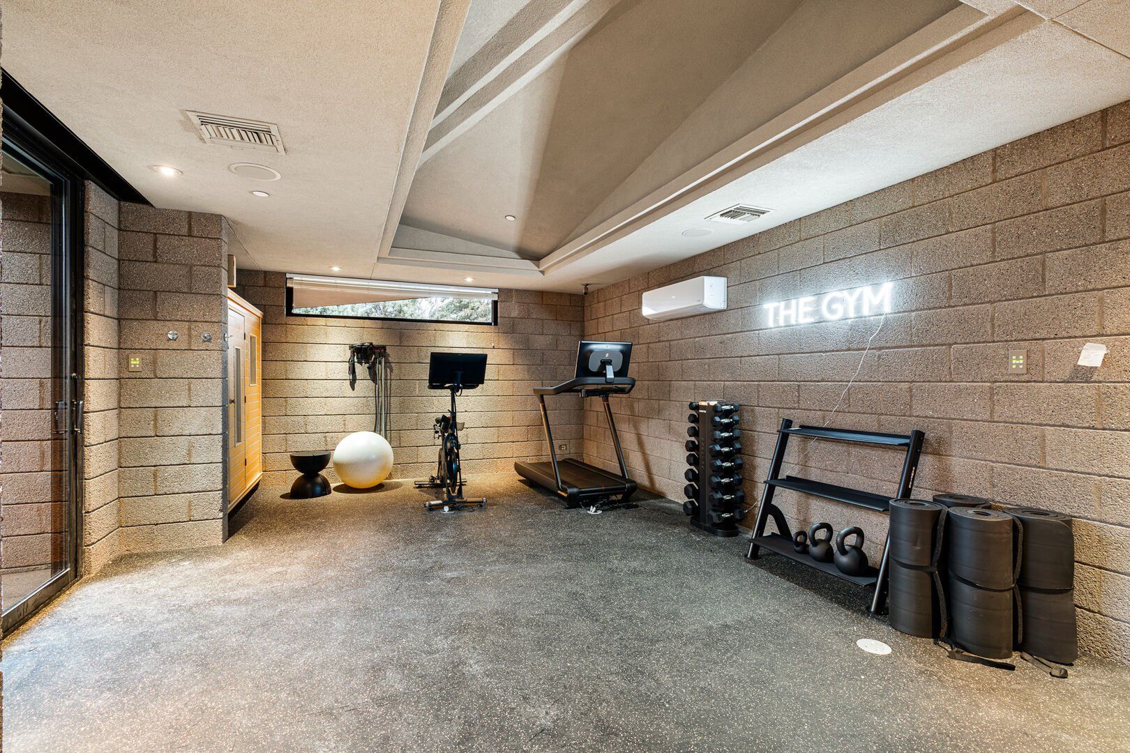 Workout gym and room with weights, tread mill, and other workout gear