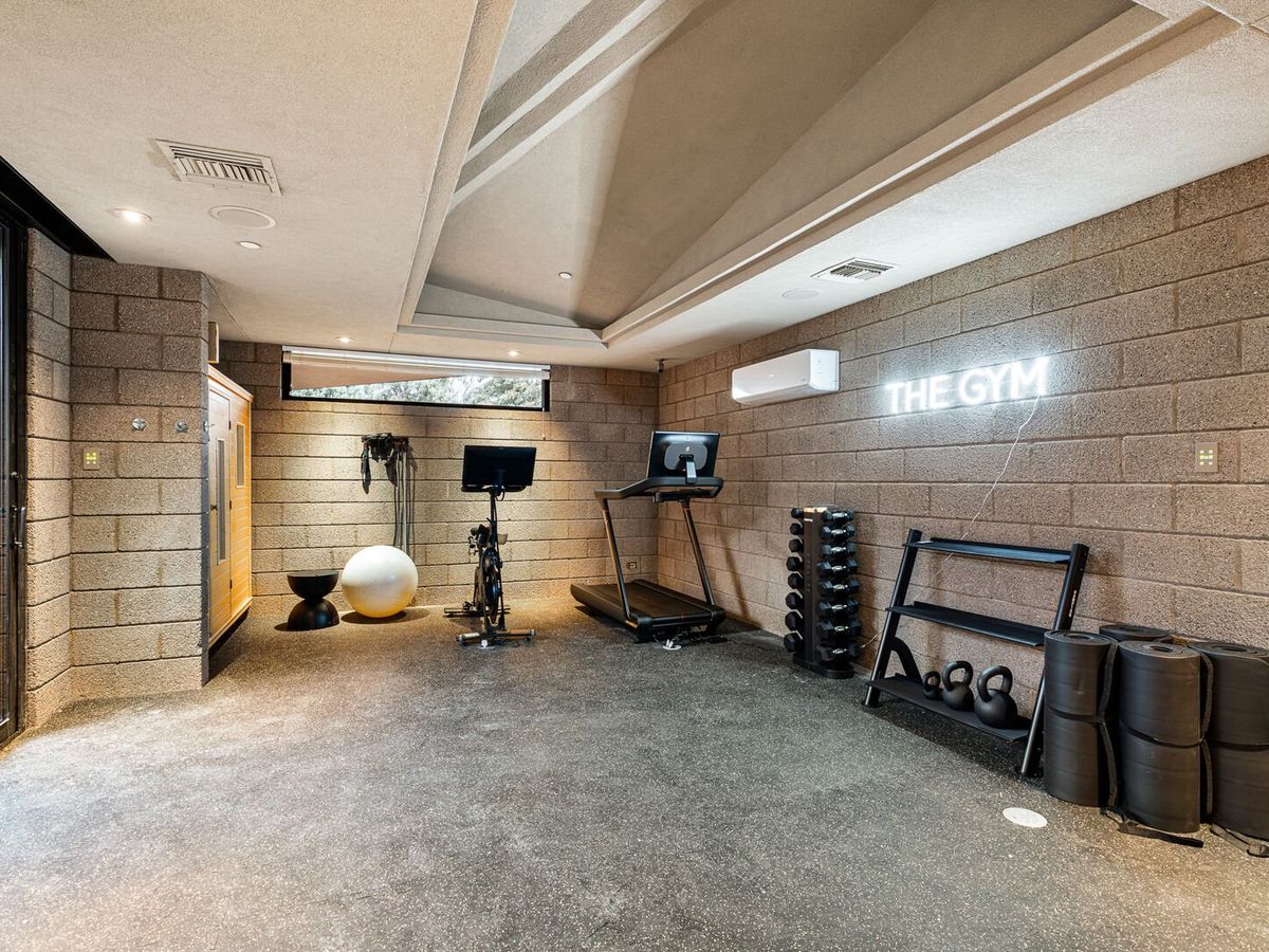Workout gym and room with weights, tread mill, and other workout gear