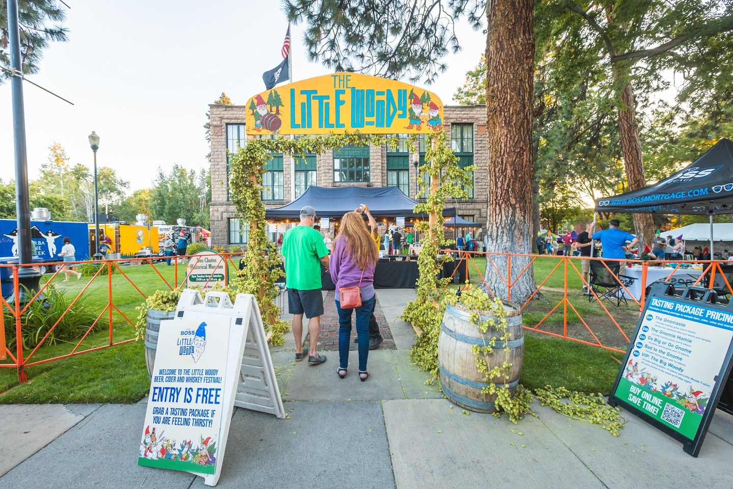 Festivalgoers enter through a whimsical archway decorated with hops vines at The Little Woody Beer, Cider, and Whiskey Festival. The relaxed outdoor vibe sets the stage for tastings and community fun.