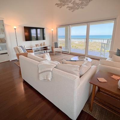 Living room with oceanfront views in Azure Waves.
