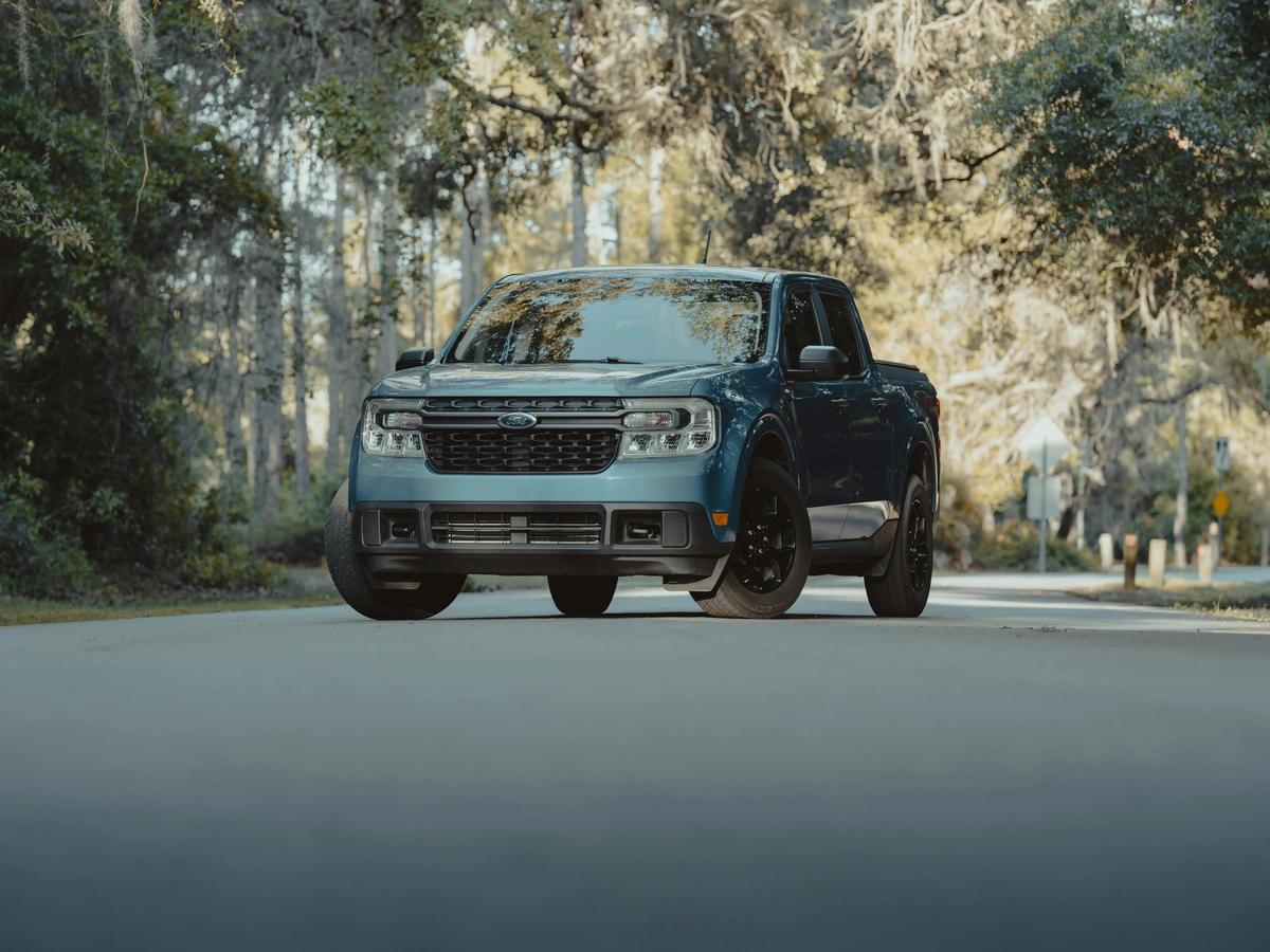 Rent a car and explore charming coastal towns, with a sleek blue Ford pickup truck ready for a scenic road trip.
