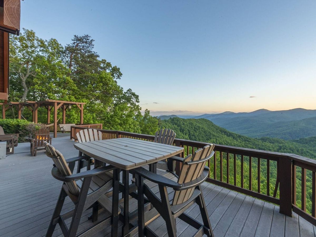 A Celestial Chalet features a spacious deck overlooking rolling mountain ridges. Guests can enjoy unforgettable sunsets and quiet mornings surrounded by nature.
