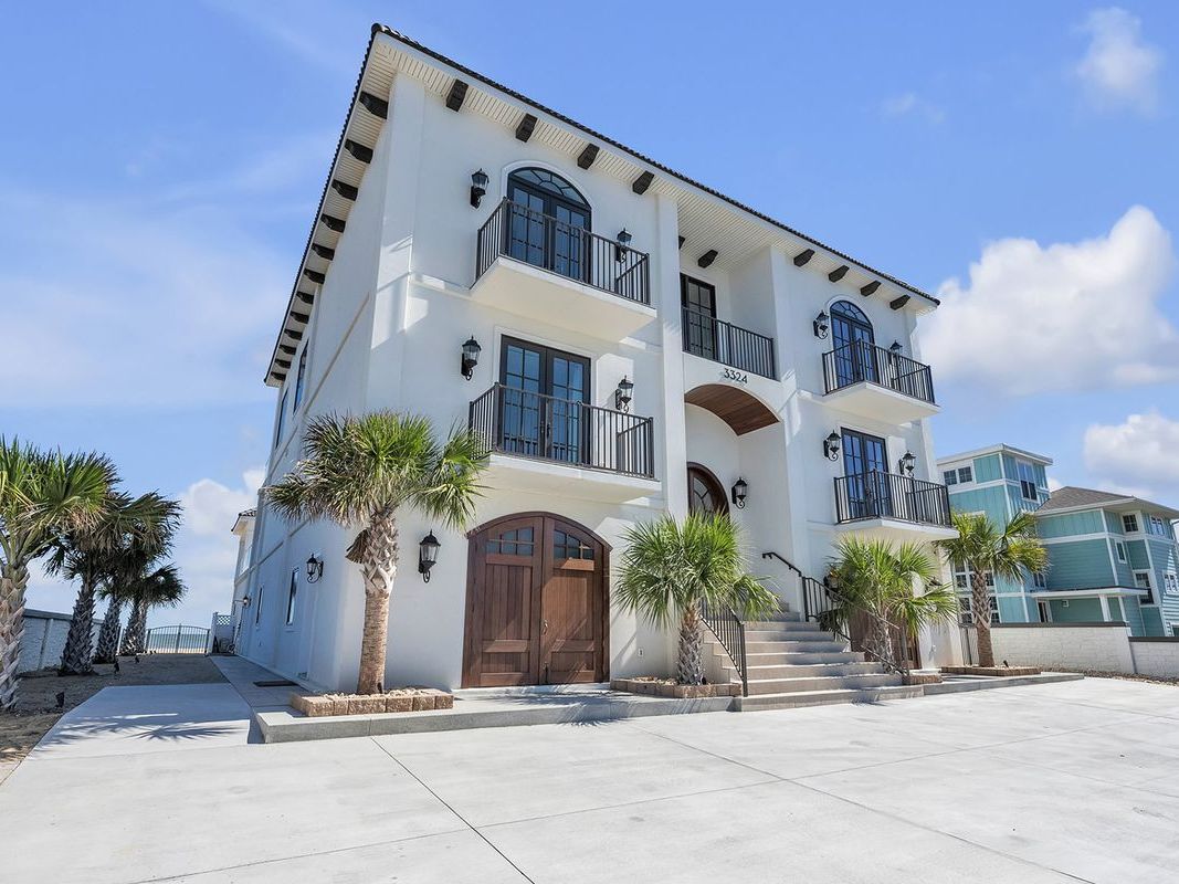 Bright and inviting beach home featuring a private pool, sun deck, and sweeping ocean views. Perfect for multi-family beach vacations or corporate retreats.