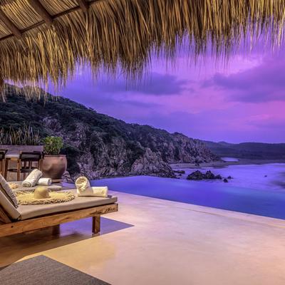 Indoor/outdoor living space with sea views.