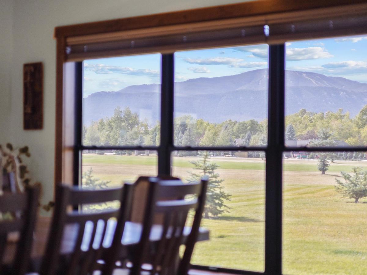 windows overloking large mountain in montana and trees in the area